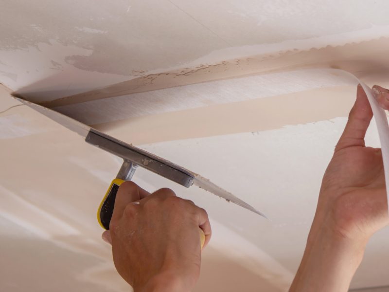 man plastering ceiling repair. Selective focus.